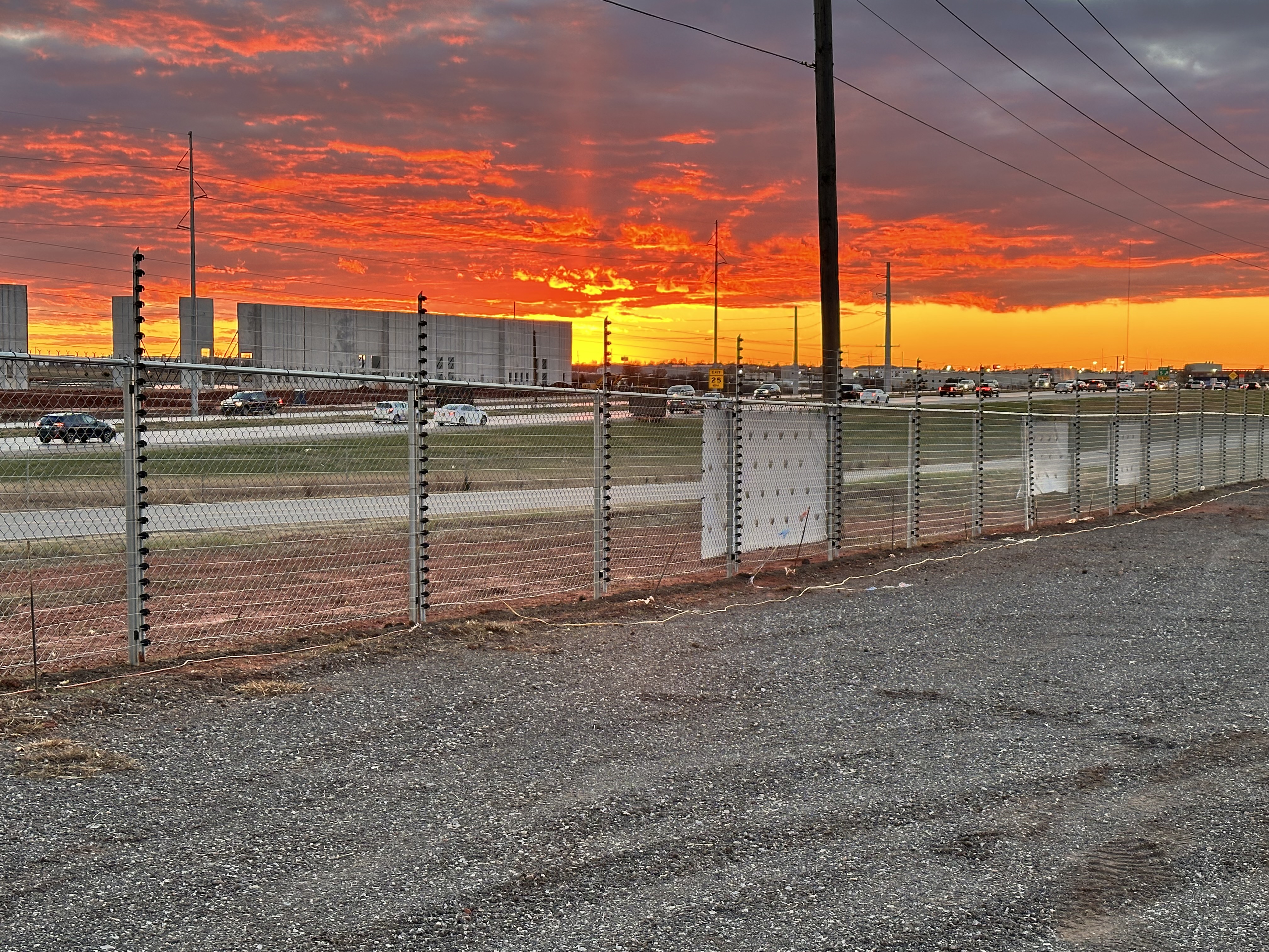 Security fence with red sky