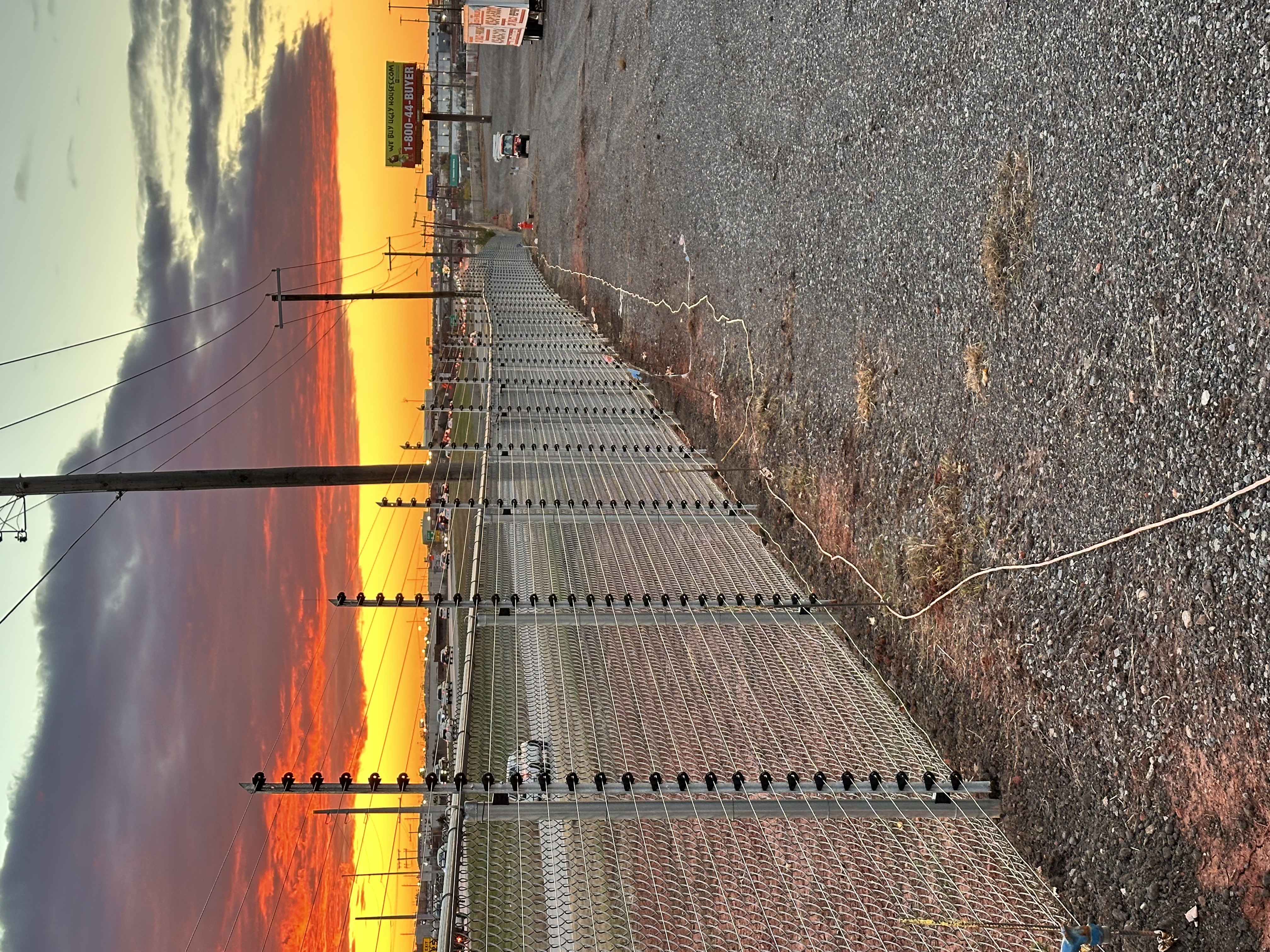 Security fence with red sky